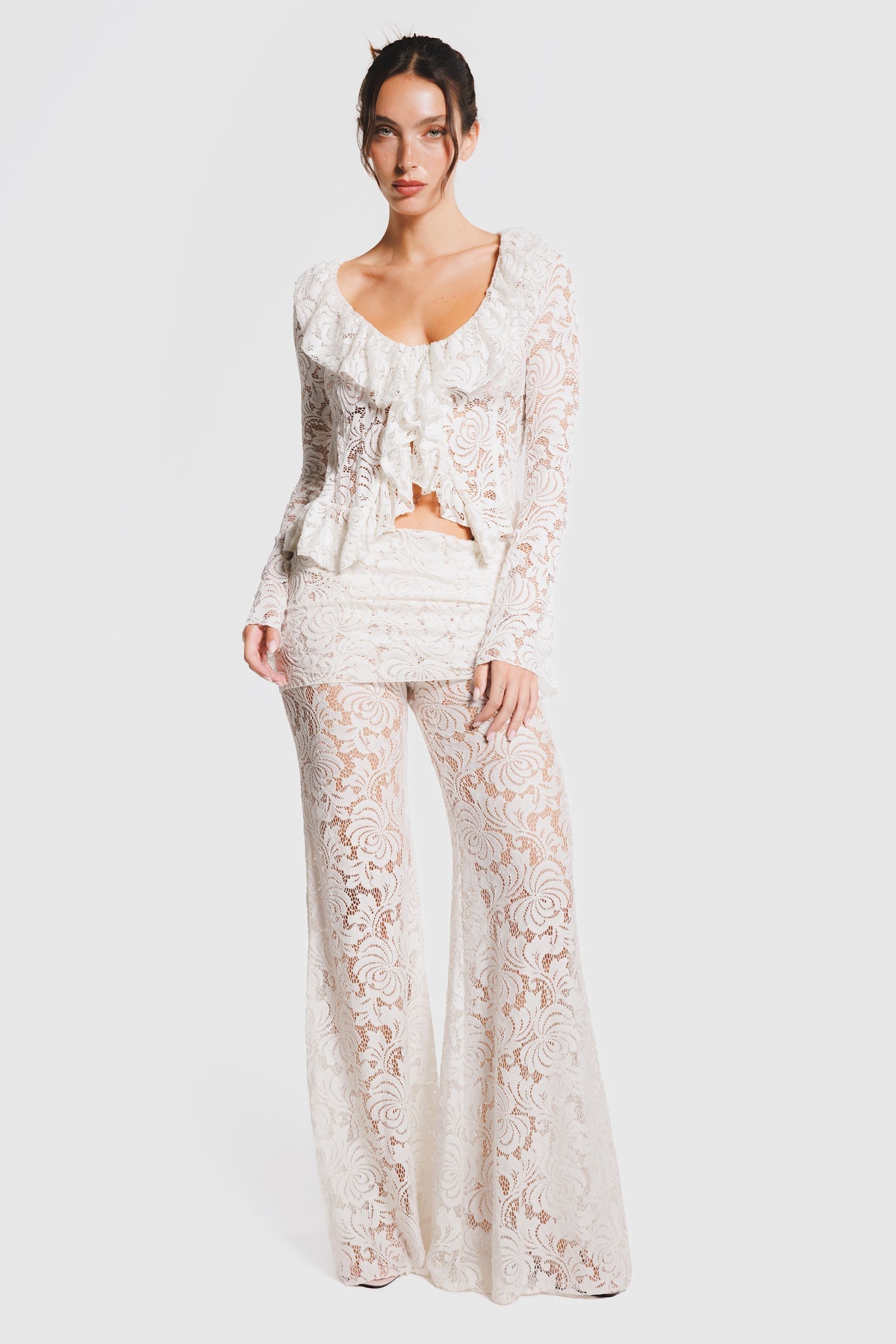 Long-sleeved shirt with ties and ruffle details, and trousers.